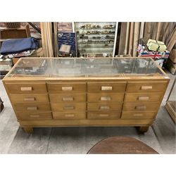 20th century oak and glazed haberdashery shop’s cabinet, glass front and sides, fitted with sixteen graduating drawers  - THIS LOT IS TO BE COLLECTED BY APPOINTMENT FROM THE OLD BUFFER DEPOT, MELBOURNE PLACE, SOWERBY, THIRSK, YO7 1QY