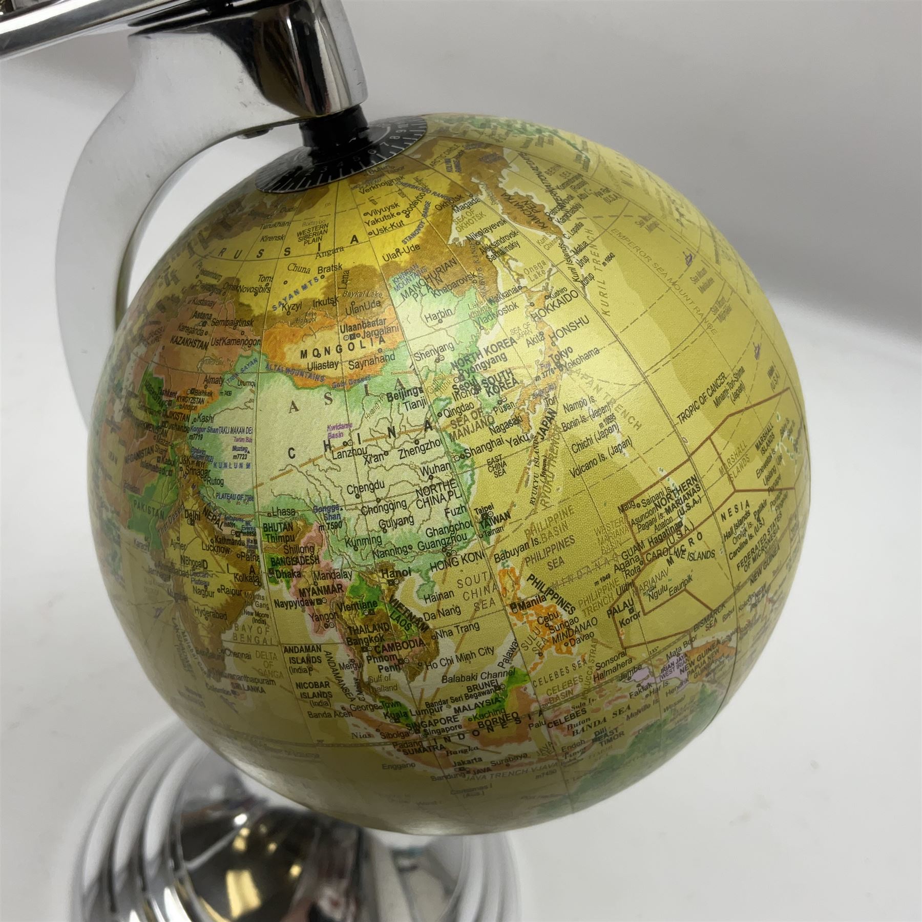 Art Deco style world globe with chrome aeroplane finial and mounts, H31cm