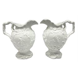 Pair of rare early/mid 19th century Copeland and Garrett white glazed pitchers, modelled in the Georgian style and moulded with the figures of Venus the Roman Goddess of Love, and Aurora the Roman Goddess of Dawn, within C scroll borders and foliate surround, the naturalistically modelled handle leading to a fruiting vine beneath the rim, upon a spreading base moulded with seashells, with printed green crowned wreath mark beneath, H20cm