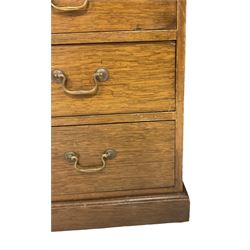 Late 19th century twin pedestal oak partner's desk, rectangular top with inset green leather writing surface, fitted with nine graduating drawers to each side, the rear drawers enclosed by panelled cupboards