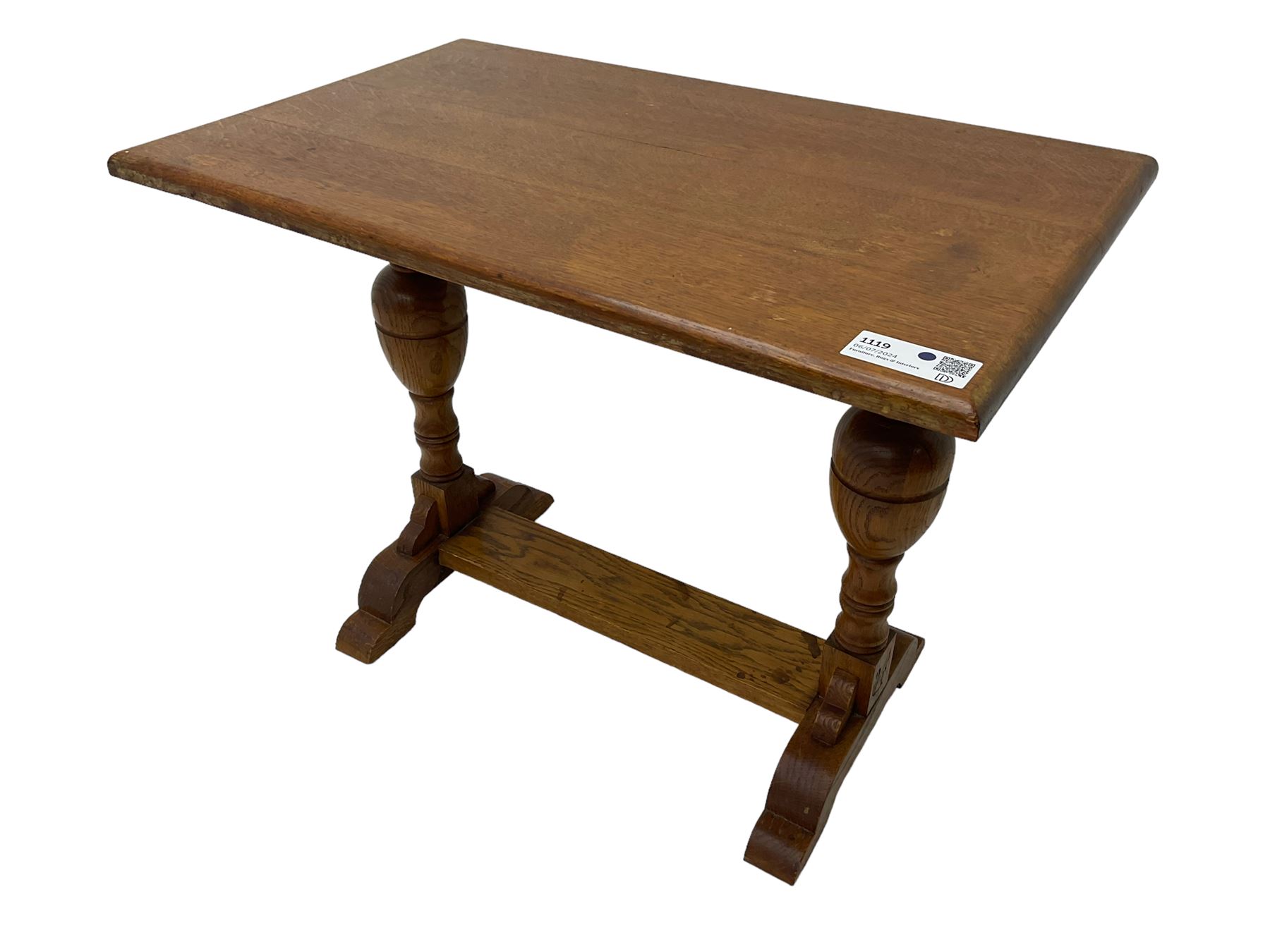 20th century oak occasional table, rectangular top on turned twin pillar supports, carved with squirrel motif, on shaped sledge feet united by stretcher 