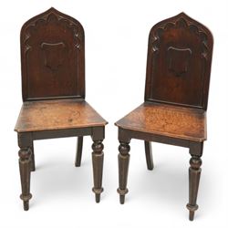 Pair of 19th century carved oak hall chairs, the arched back carved with moulded scalloped...