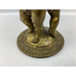 Brass centrepiece modelled as two cherubs supporting a marble bowl, stood upon a foliate design base, H32cm