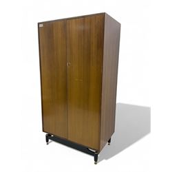 G-Plan - mid 20th century teak double wardrobe, set on a black painted base with brass-capped feet