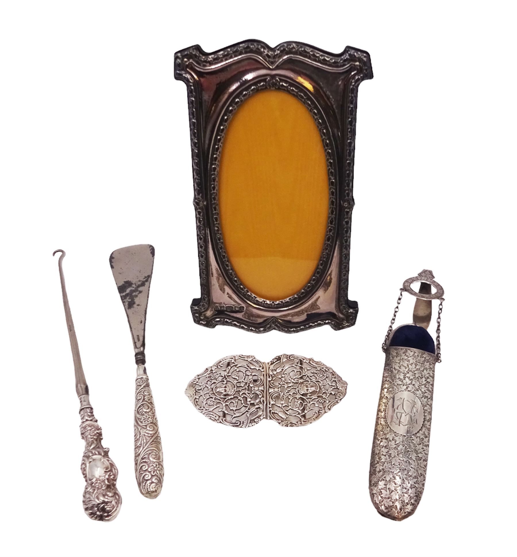 Group of silver, comprising Victorian spectacles case, with clip, hallmarked George Unite, Birmingham 1892, belt buckle with openwork decoration, silver handled button hook and shoe horn and a modern silver mounted photograph frame, all hallmarked, frame H19cm