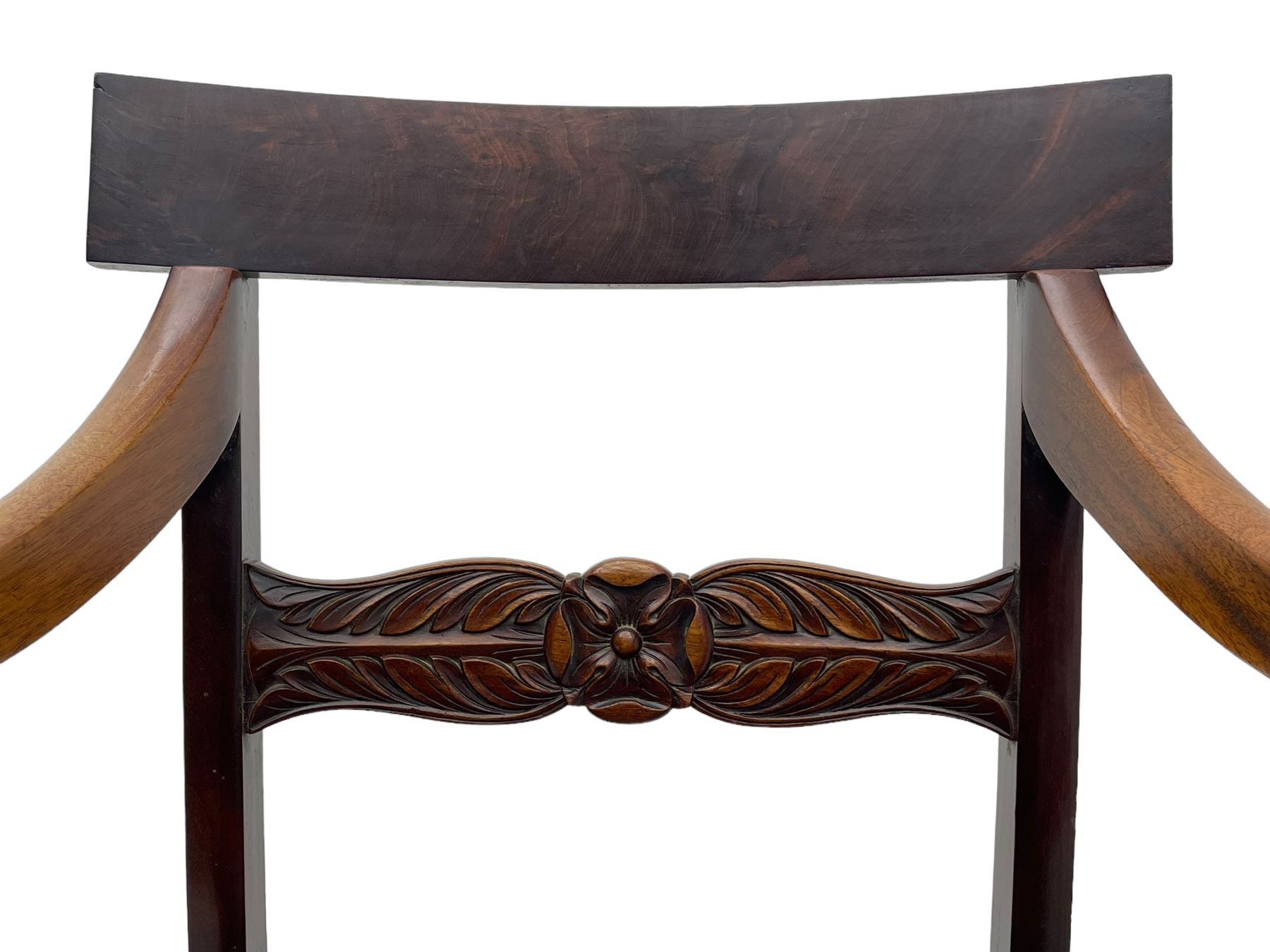 Set of six (4+2) early 19th century mahogany dining chairs, figured bar back over rose and curled leaf carved middle rail, drop-in seats upholstered in brown fabric, on turned front supports 