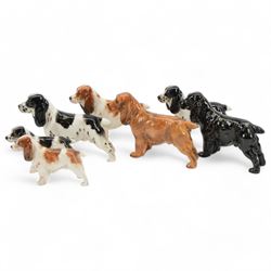 Seven Royal Doulton spaniels, in different colourways  