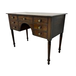 George III mahogany kneehole dressing or side table, moulded rectangular top over seven cock-beaded drawers, on ring turned support 