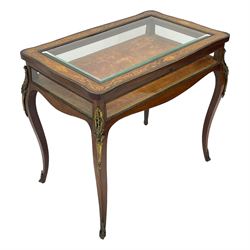 Victorian inlaid rosewood bijouterie table cabinet, shaped form, enclosed by hinged bevel glazed lid with shell and floral inlays, fabric lined interior, glazed sides within foliate cast gilt metal edging, on cabriole supports with floral cast gilt metal mounts and terminal caps 