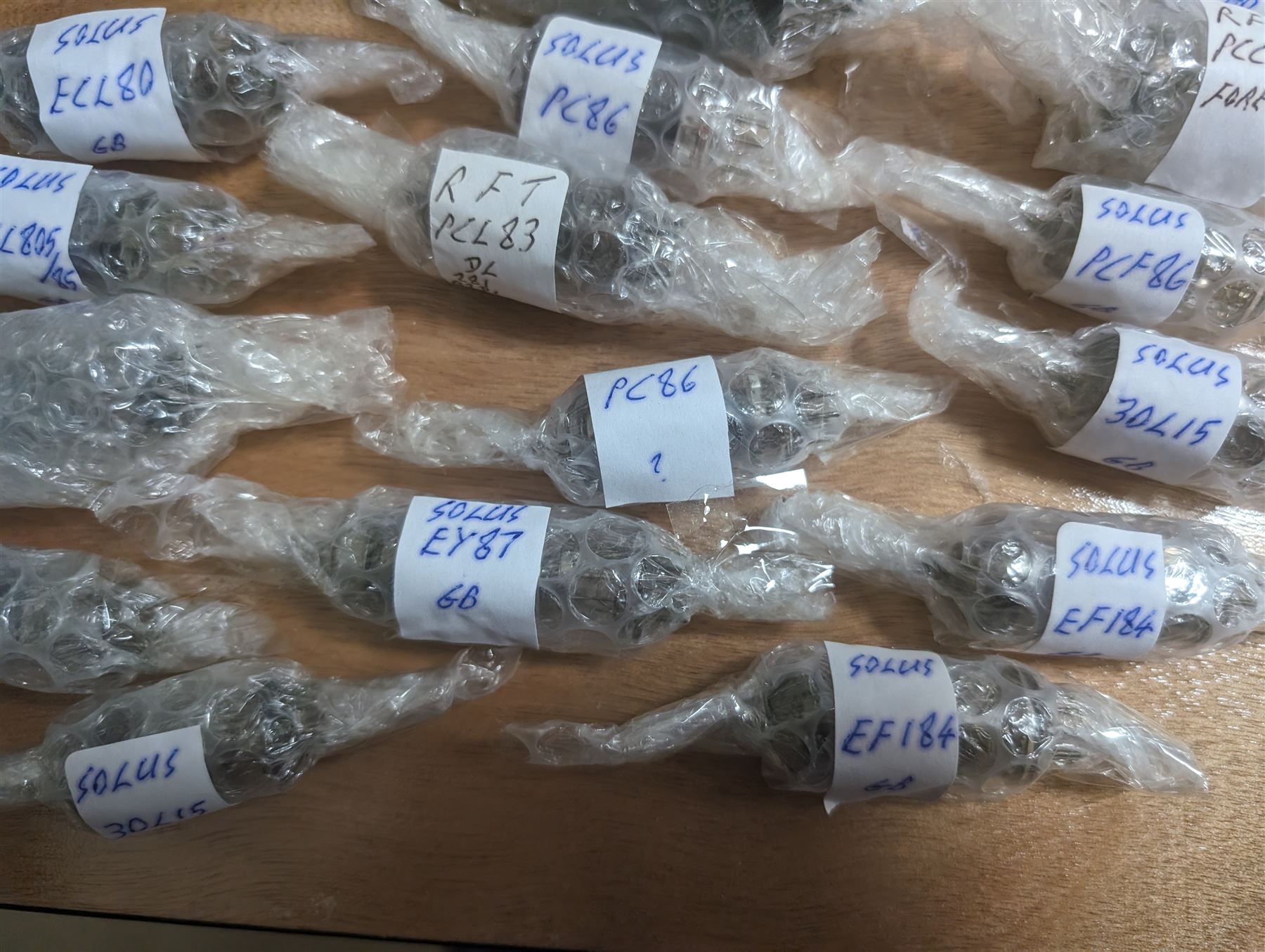 Large collection of thermionic valves/vacuum tubes, by various makers, mostly wrapped in bubble wrap with identifying stickers, together with a collection of empty valve boxes including Pinnacle, Mullard etc