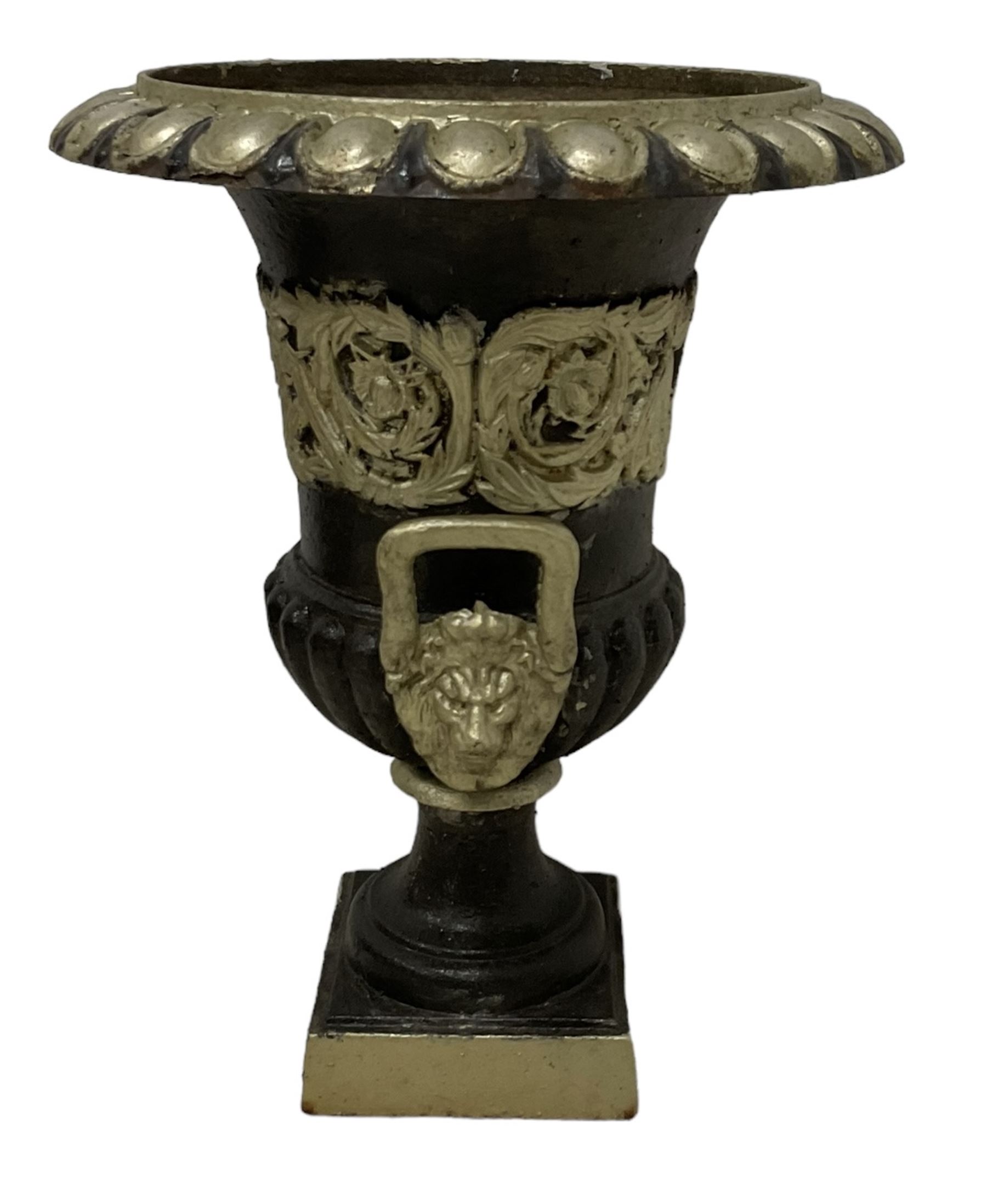 20th century cast iron Campana-shaped urn on plinth, with scrolling foliate relief decoration, in ebonised and silver painted finish