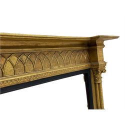 Regency design giltwood overmantel mirror, projecting cornice over pointed arcade frieze and foliate moulded upper edge, plain mirror plate within reed moulded ebonised slip, flanked by cluster columns with acanthus and scroll decorated Composite order capitals 