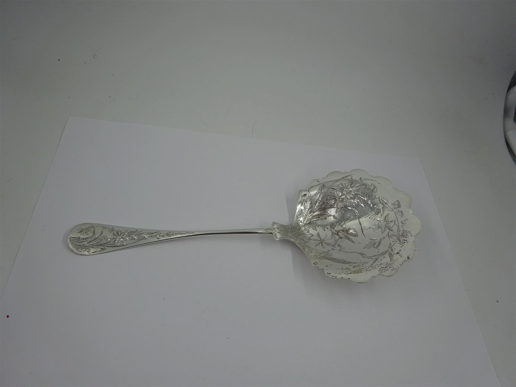 French silver aesthetic movement serving spoon, the scallop edged bowl engraved with a bird amongst flowers and foliage, stamped with Minerva's head standard and weevil export mark, L23cm