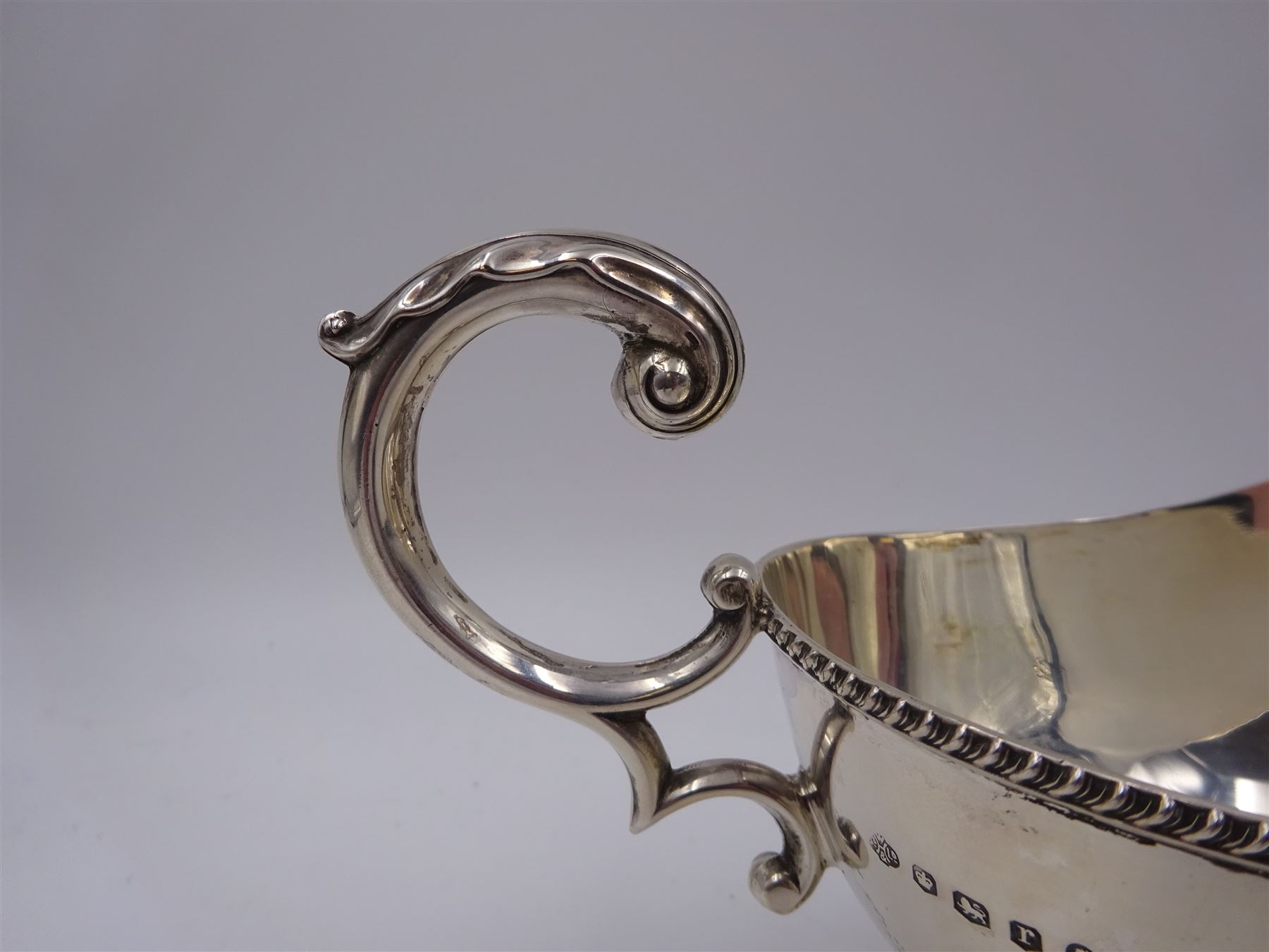 1930s silver sauce boat, of typical form, with oblique gadrooned rim and acanthus capped flying C scroll handle, by William Hutton & Sons Ltd, Sheffield 1934, H11cm