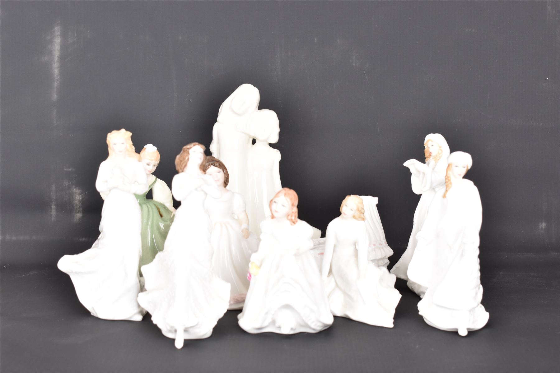 Eight Royal Doulton figures, including Fair Maiden, Across the Miles, Christmas Carols etc together with two Royal Worcester figures   