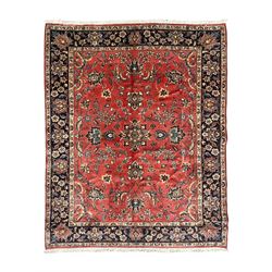 Persian Kashan red ground rug, the field decorated with trailing leafy branches and large ...