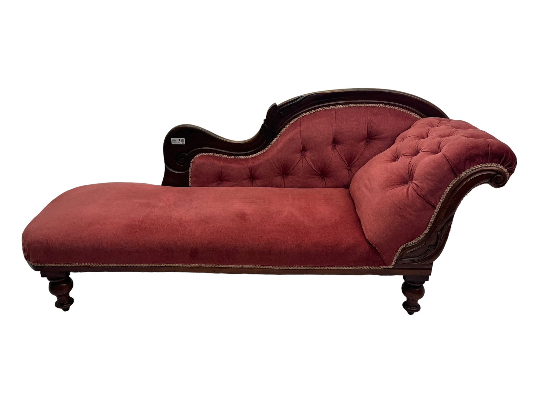 Victorian mahogany framed chaise longue, upholstered in pink velvet, the scrolled back with button-tufting, on turned feet