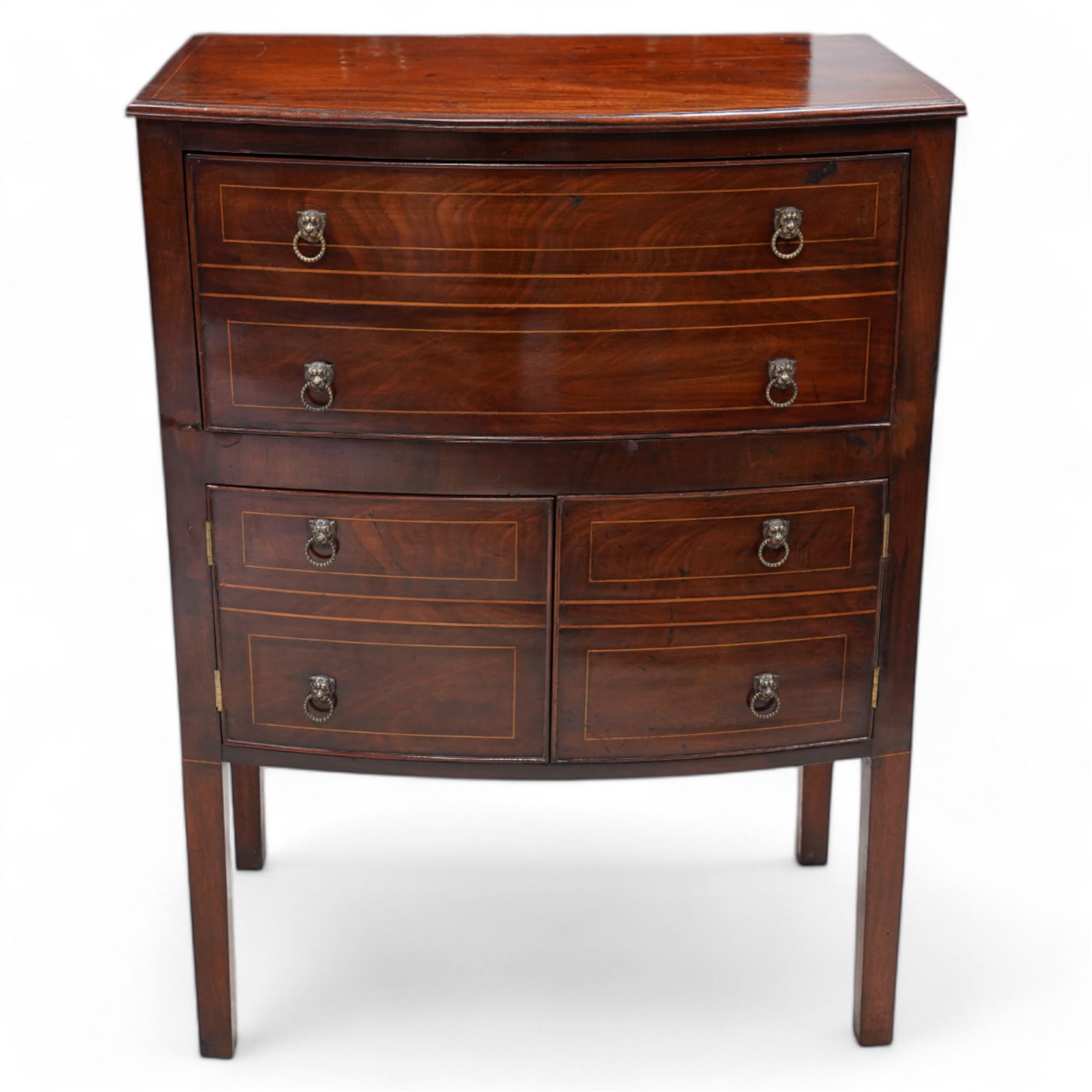 George III mahogany bow-fronted night cabinet, moulded top with box wood stinging over single drawer and double cupboard, with lion mask and hoop handles, on square supports 