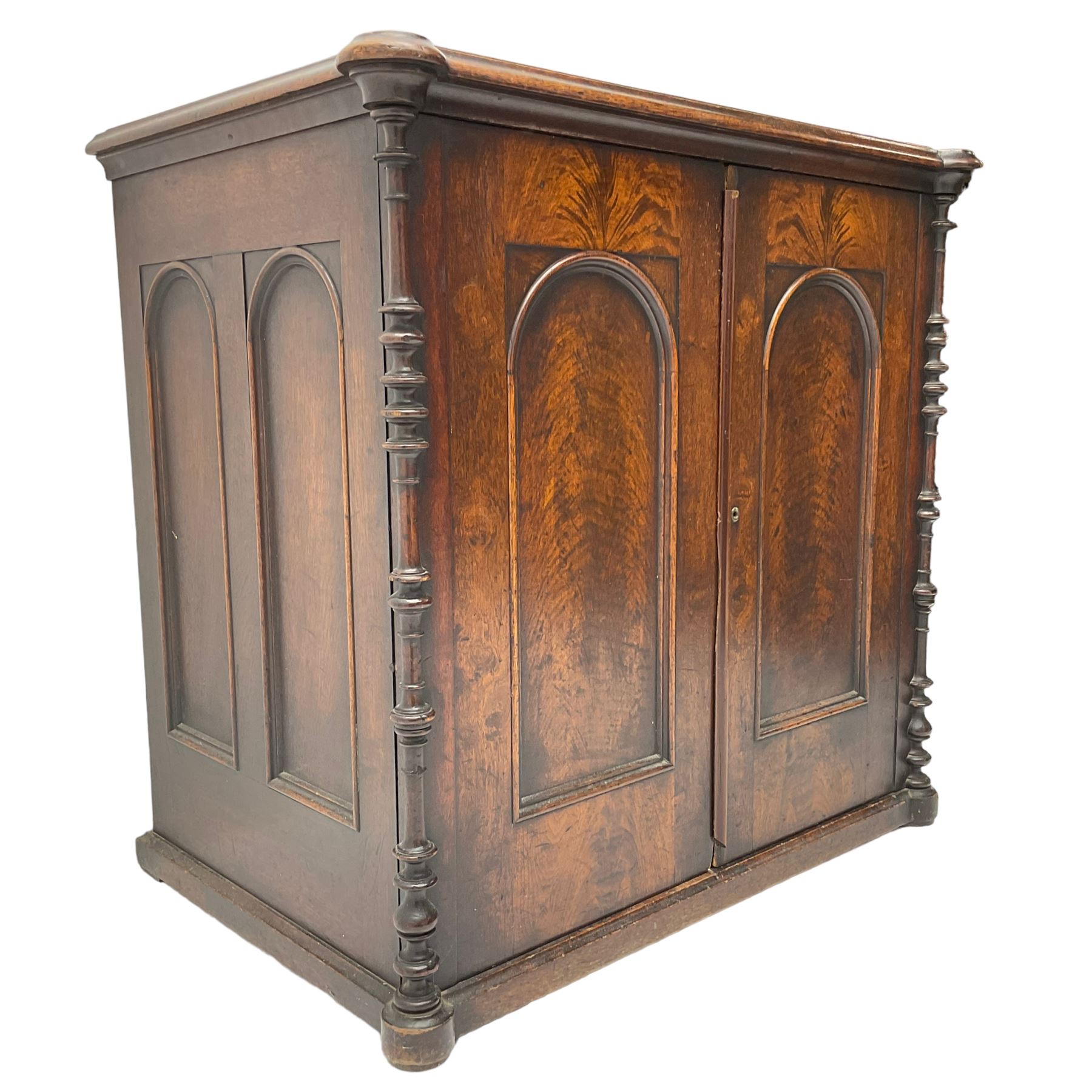 Victorian lacquered mahogany cupboard, fitted with two arch panelled doors enclosing two shelves, flanked by split turned uprights