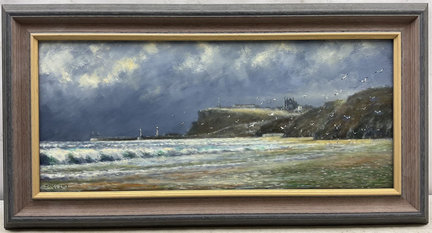 Jack Rigg (British 1927-2023): 'Between Sandsend and Whitby', oil on board signed and dated 2013, titled verso 29cm x 69cm