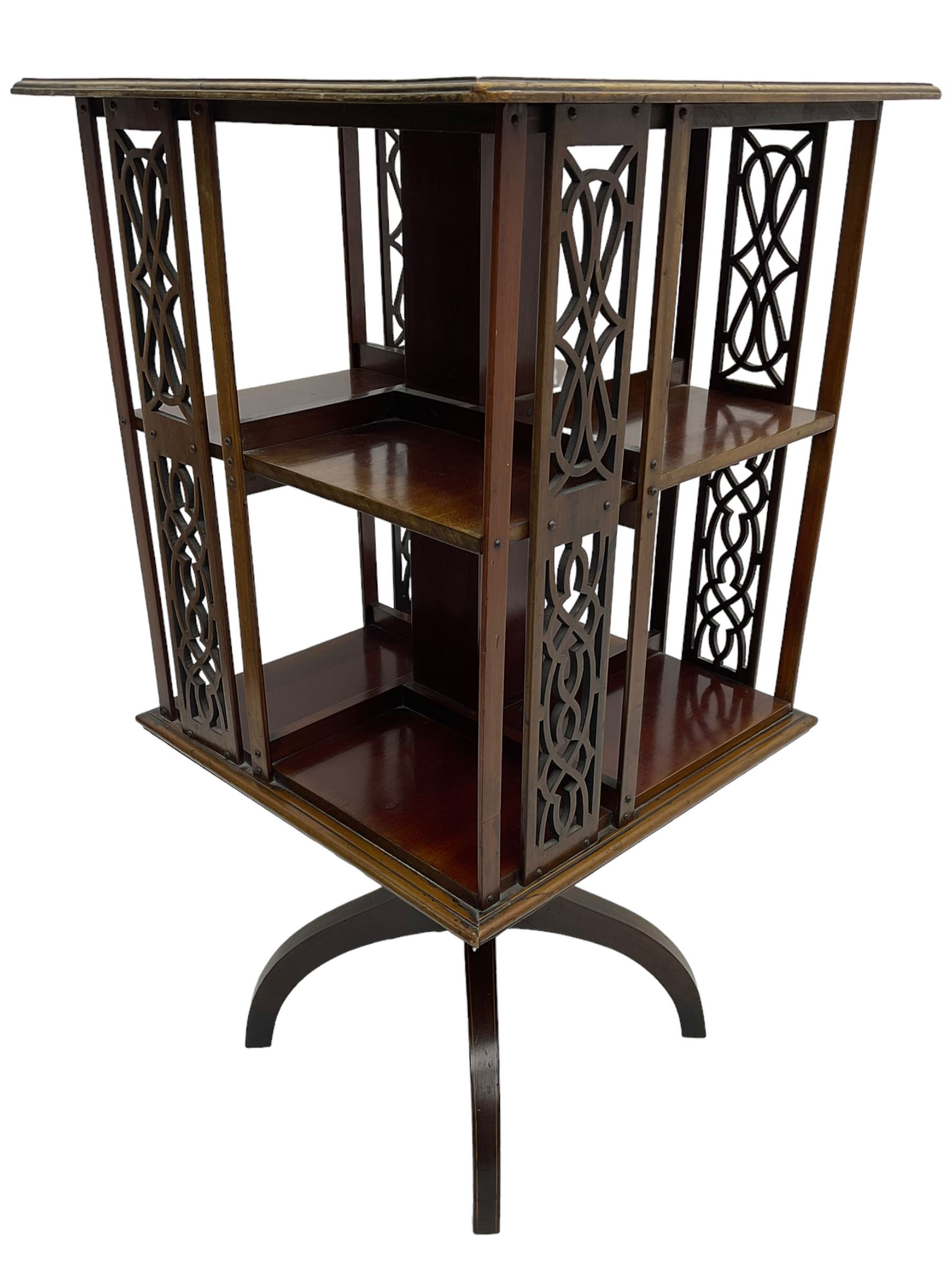 Edwardian mahogany revolving bookcase, square moulded top with satinwood band, two tiers with pierced vertical splats, on four curved supports 