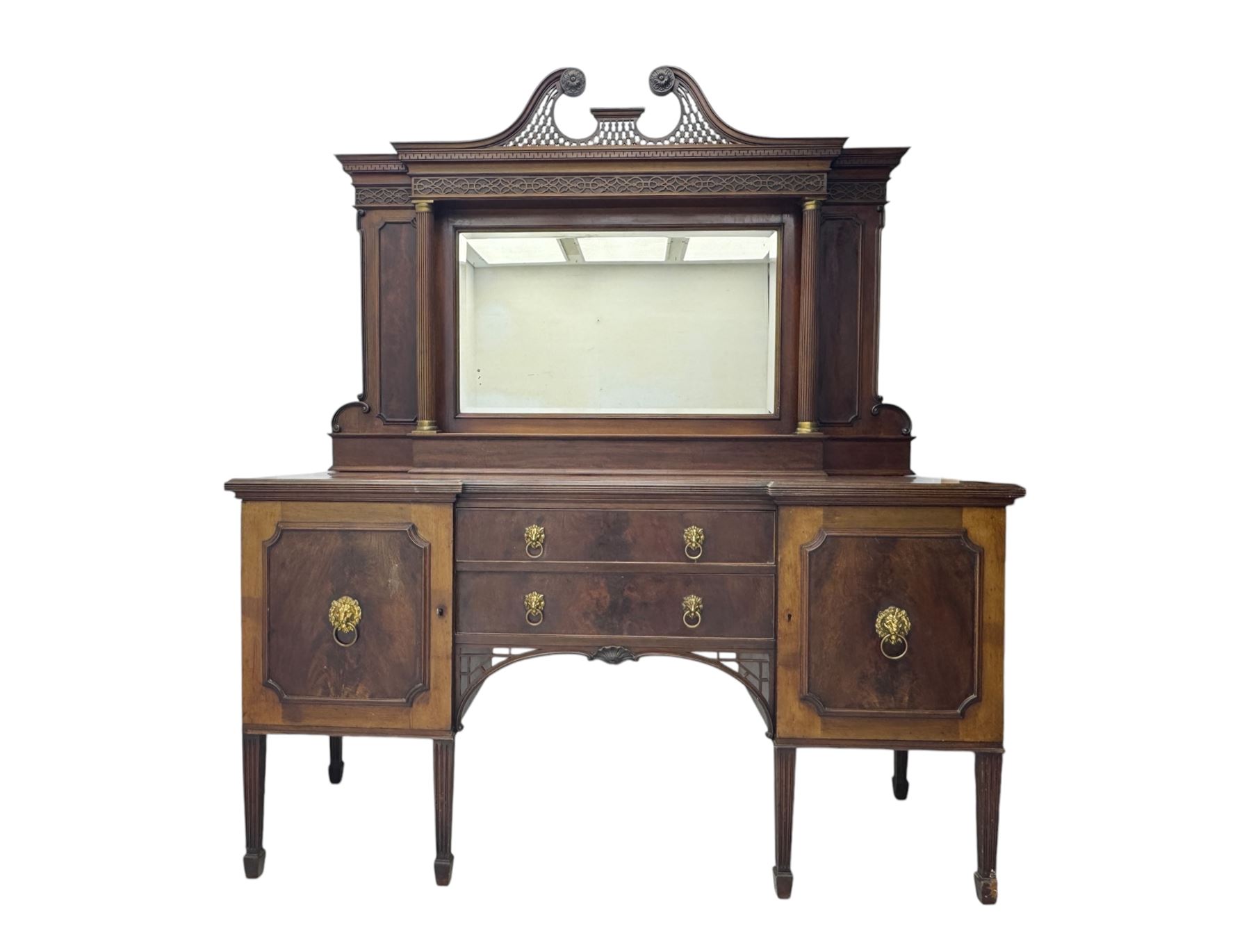 19th century mahogany sideboard, raised mirror back with carved fretwork and two fluted columns, above two cupboards and two drawers with lion mask handles