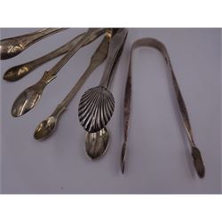 Four pairs of silver sugar tongs, to include three George III pairs comprising a bright cut engraved example, hallmarked Peter, Ann & William Bateman, London 1801, a fiddle pattern example, with engraved initials, hallmarked Thomas Wallis II, London 1806 and one other, hallmarked Stephen Adams II, London 1800, together with an Edwardian pair, with shell bowls, hallmarked Mappin & Webb Ltd, Sheffield 1909