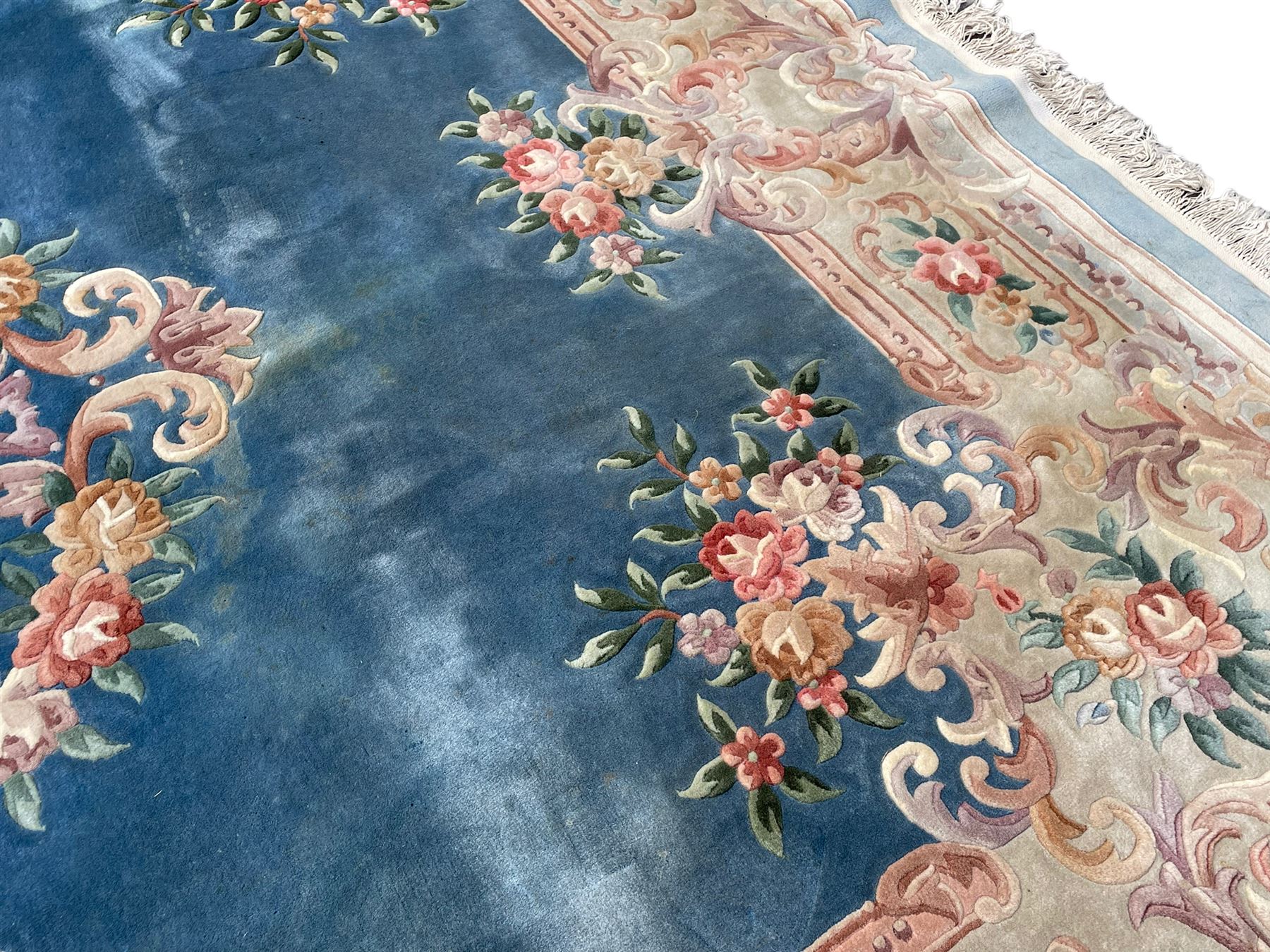 Large Chinese blue ground woollen carpet, overall floral design, central oval medallion surrounded by scrolling floral decoration, wide border with decorated with floral bouquets 