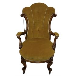 19th century walnut framed open armchair, scallop shaped back with c-scroll uprights, upholstered in yellow buttoned velvet fabric with sprung seat, arm terminals carved with acanthus leaves, raised on scrolling cabriole supports with castors