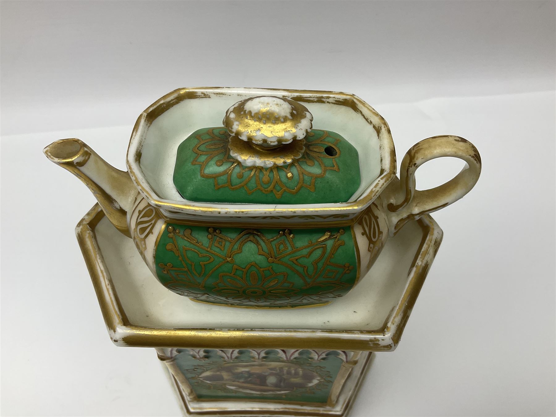 Two 19th century continental teapots and warmers, each teapot upon a hexagonal warming base, the first example painted with landscape scenes, the second with nesting birds in gilt branches, H28cm