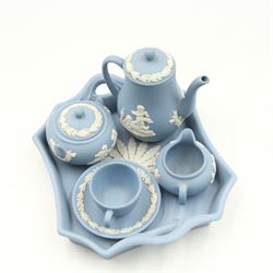 Wedgwood Jasperware miniature tea set for one, on a matched tray, oval scent bottle with silver cover, four caddy spoons, miniature bell, seven thimbles, together with a cased pair of portrait medallions of Josiah Wedgwood FRS and Thomas Bentley 