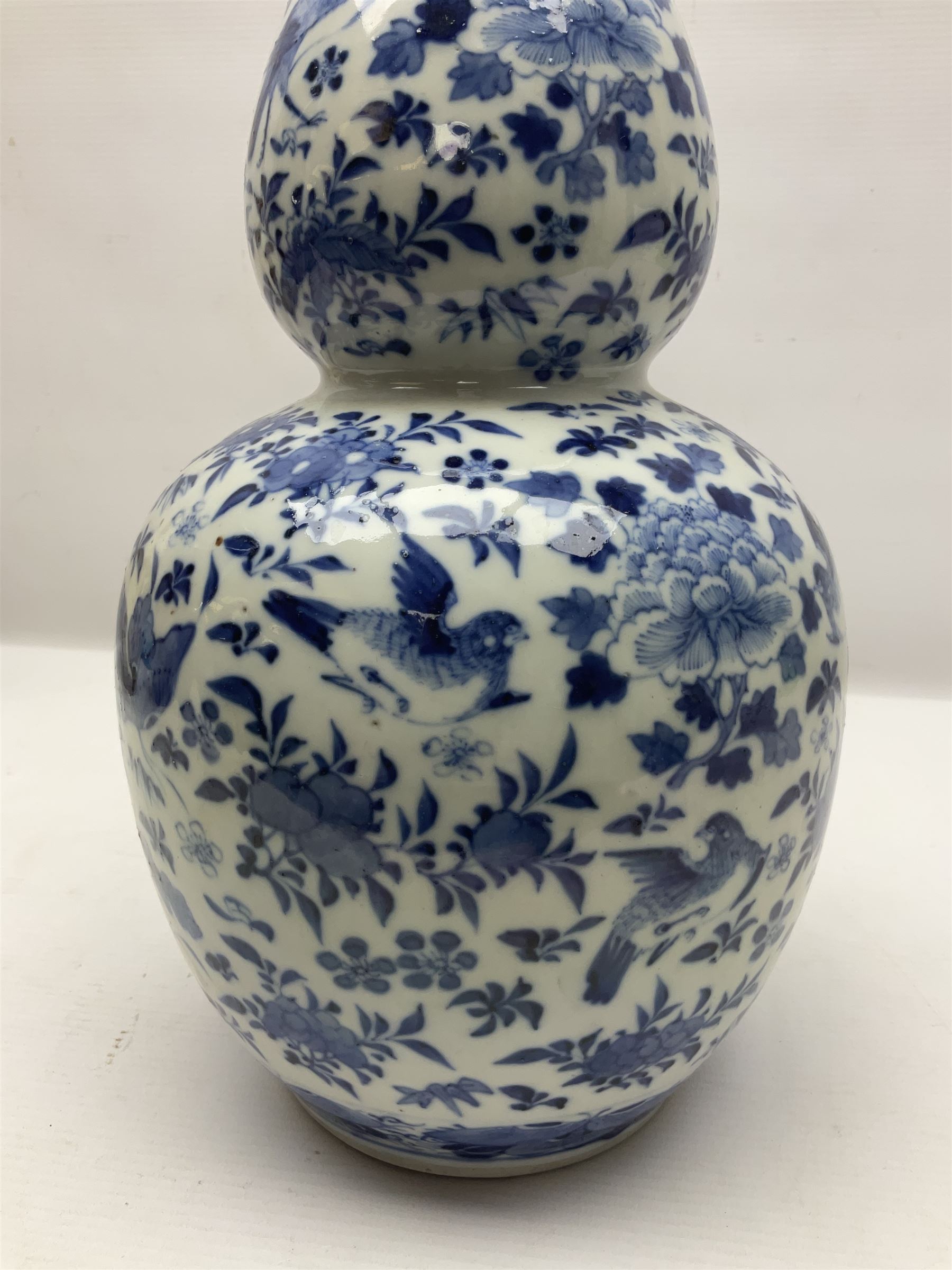 19th century Chinese blue and white double gourd form vase, decorated with blooming peonies and birds in flight, H36cm