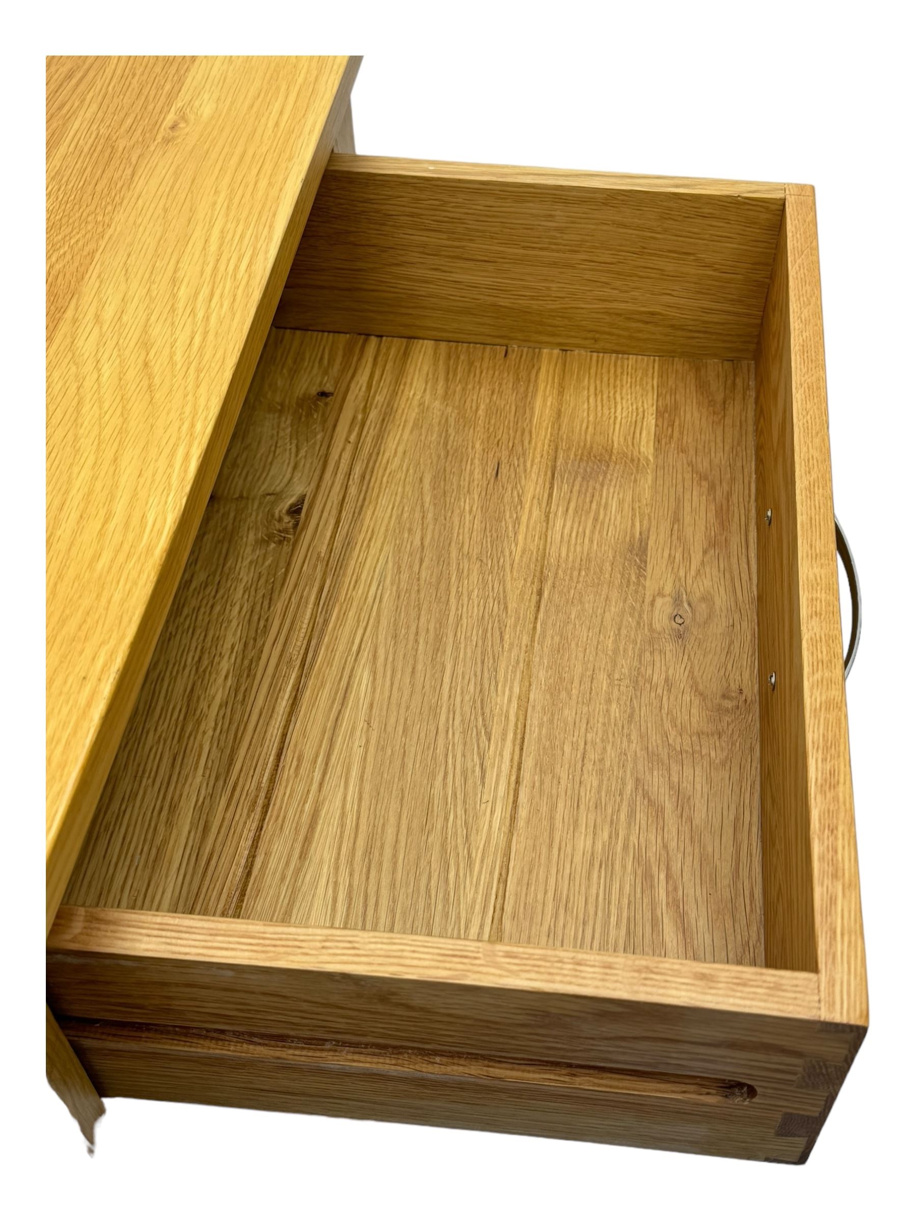 Contemporary light oak twin pedestal desk, fitted with three drawers over two cupboards with chrome handles, the central drawer with hinged front panel revealing pull-out keyboard tray, on plinth base