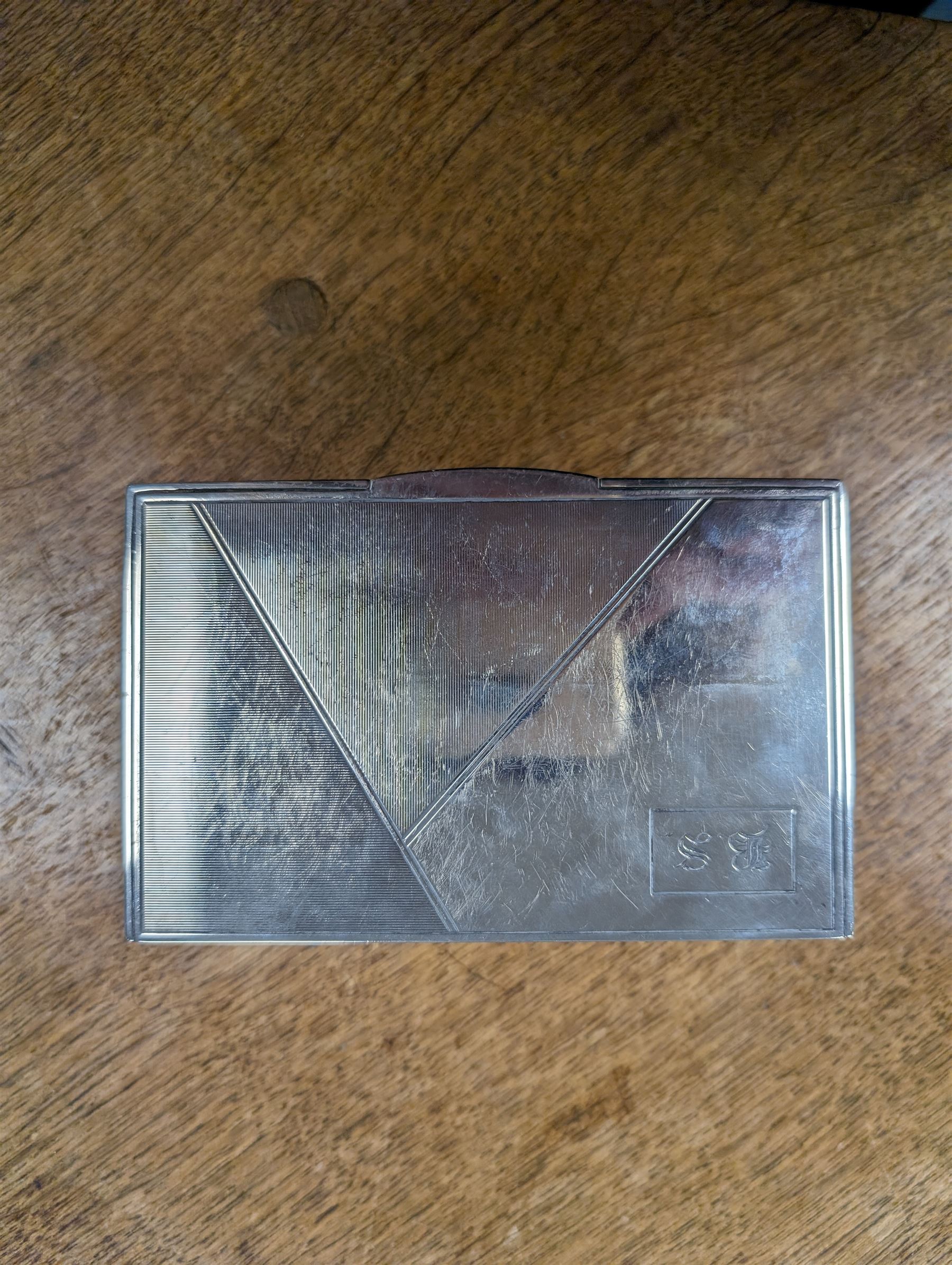 1930s silver mounted cigarette box, of rectangular form, with engine turned decoration and engraved cartouche to hinged lid, opening to reveal a softwood interior, hallmarked London 1930, maker's mark worn and indistinct