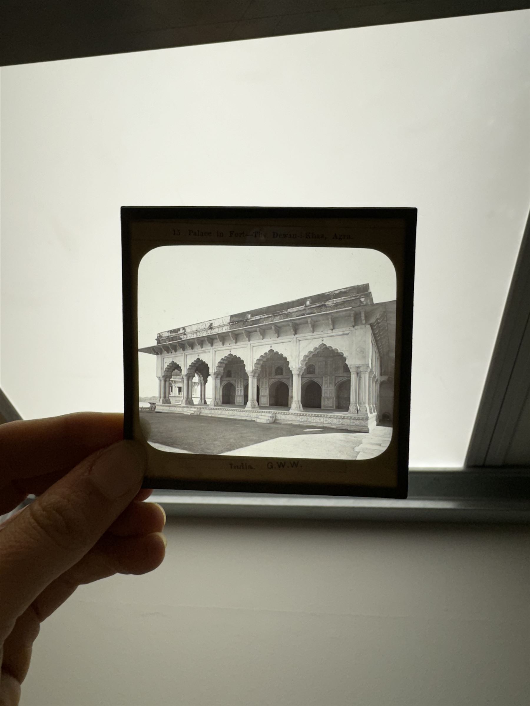 Collection of magic lantern slides, predominantly depicting views of India, with scenes including including the Taj Mahal, tombs, monuments, street scenes, people and animals, in compartmentalised wooden case 