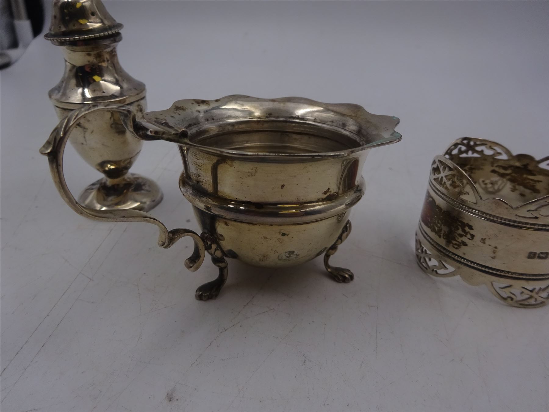 Group of silver, including mustard pot, pepper shaker and napkin ring, all hallmarked 