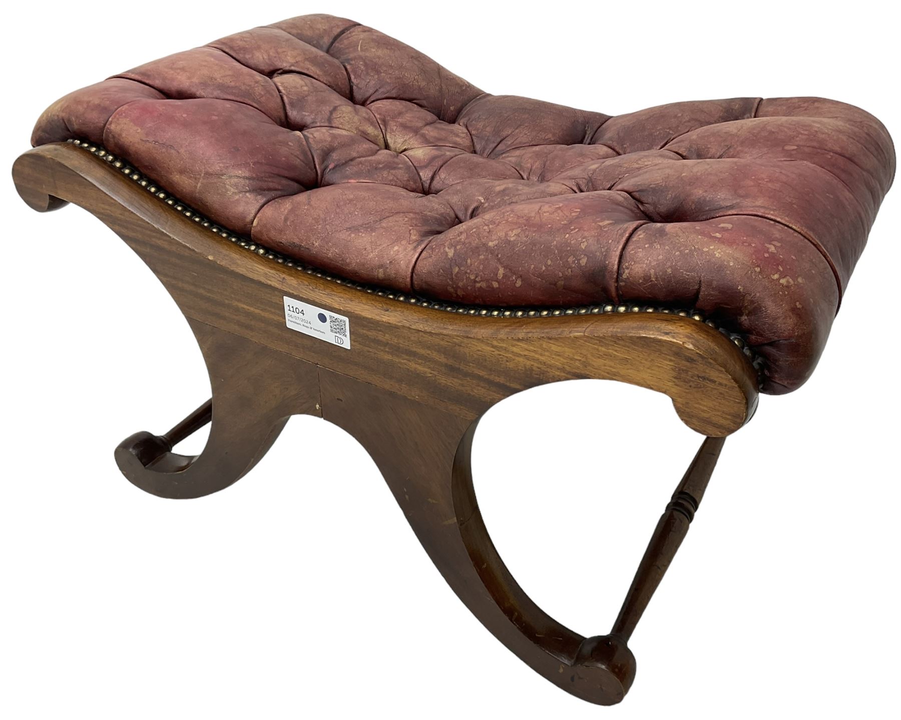 Late 20th century mahogany curved x-framed footstool, upholstered in buttoned red leather, splayed supports united by turned stretchers 