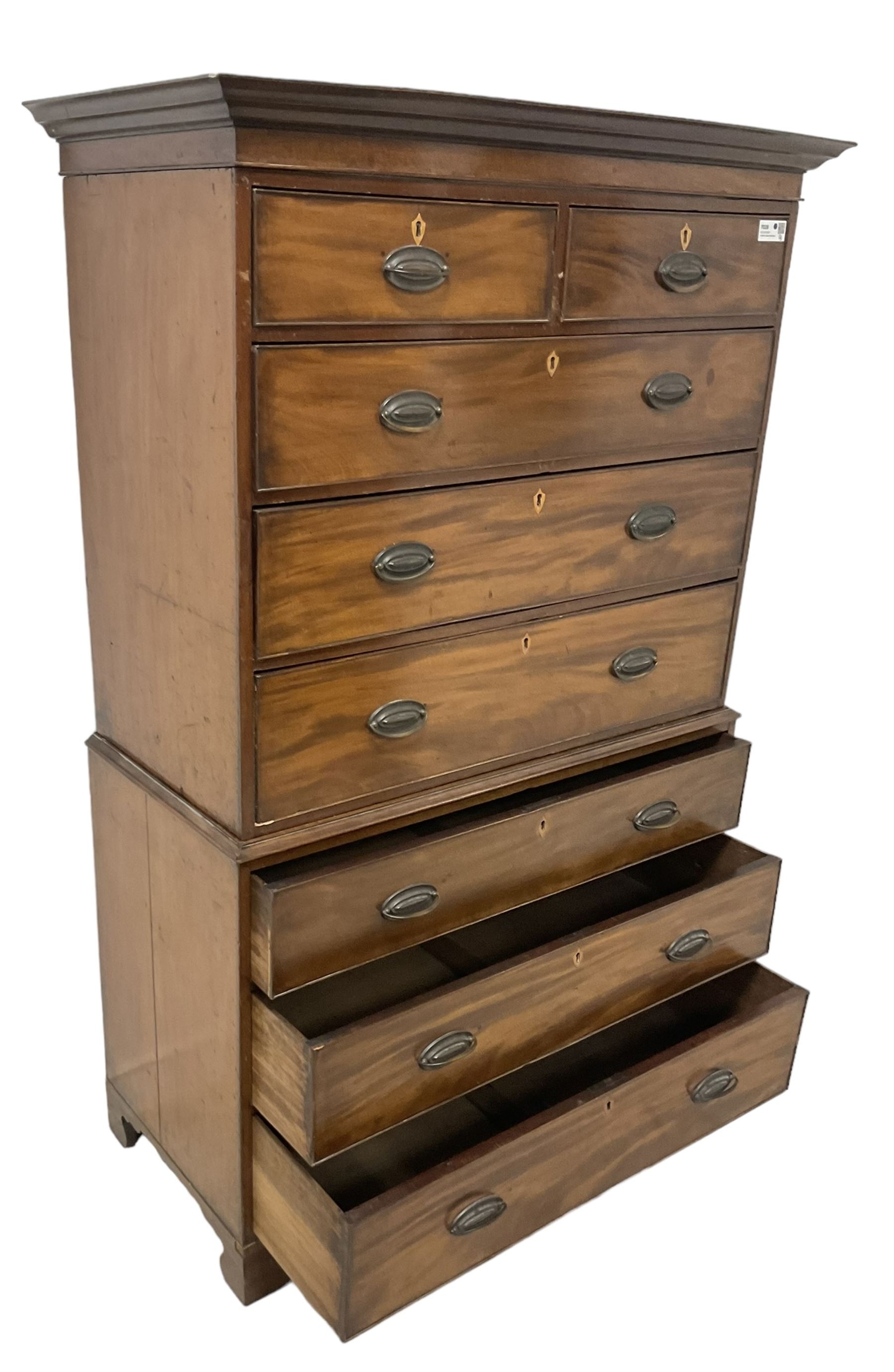 Early 19th century mahogany chest-on-chest, projecting cornice over banded frieze, fitted with two short over six long graduating cock-beaded drawers with bone and timber escutcheons, on bracket feet