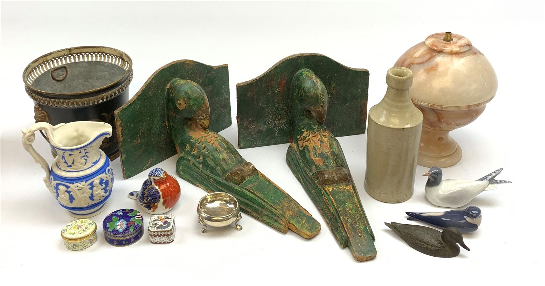 A mixed group of assorted collectables, to include an Georgian silver open salt, hallmarks worn and indistinct, a pair of painted wooden wall brackets, modelled in the form of parrots, a toleware planter, with twin lion mask ring handles and detailed in gilt with a quiver of arrows, Victorian Parian jug, with registration lozenge beneath, Crown Derby paperweight modelled as a robin, with gold stopper, two Royal Copenhagen birds, a bronze paperweight modelled in the form of a duck, Crummles enamel box, etc. 