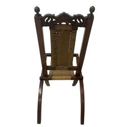 Victorian Aesthetic Movement mahogany framed folding campaign chair, pierced and carved cresting rail with carved and chamfered uprights, rattan back and seat