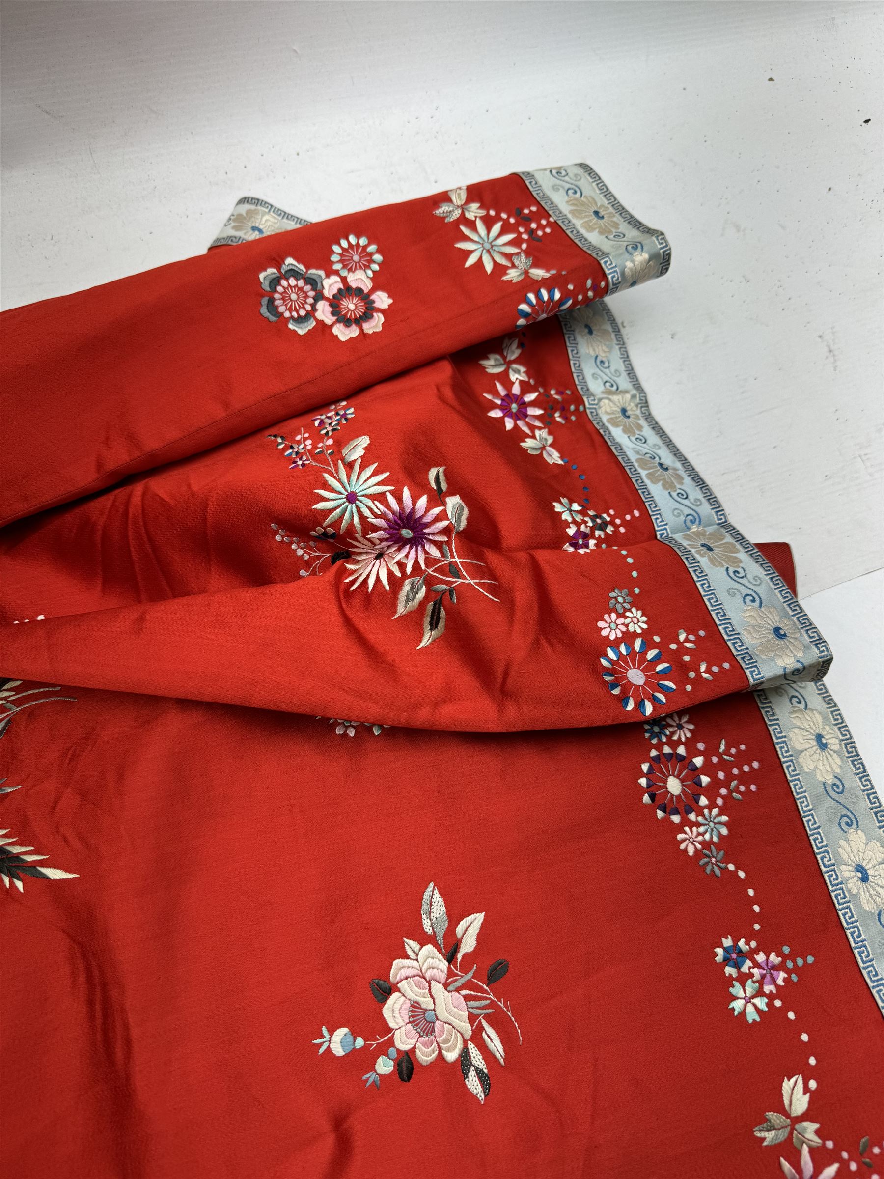 Early 20th century Chinese Han silk skirt, embroidered with flowers and butterflies, on a red ground, purchased from Liberty, London