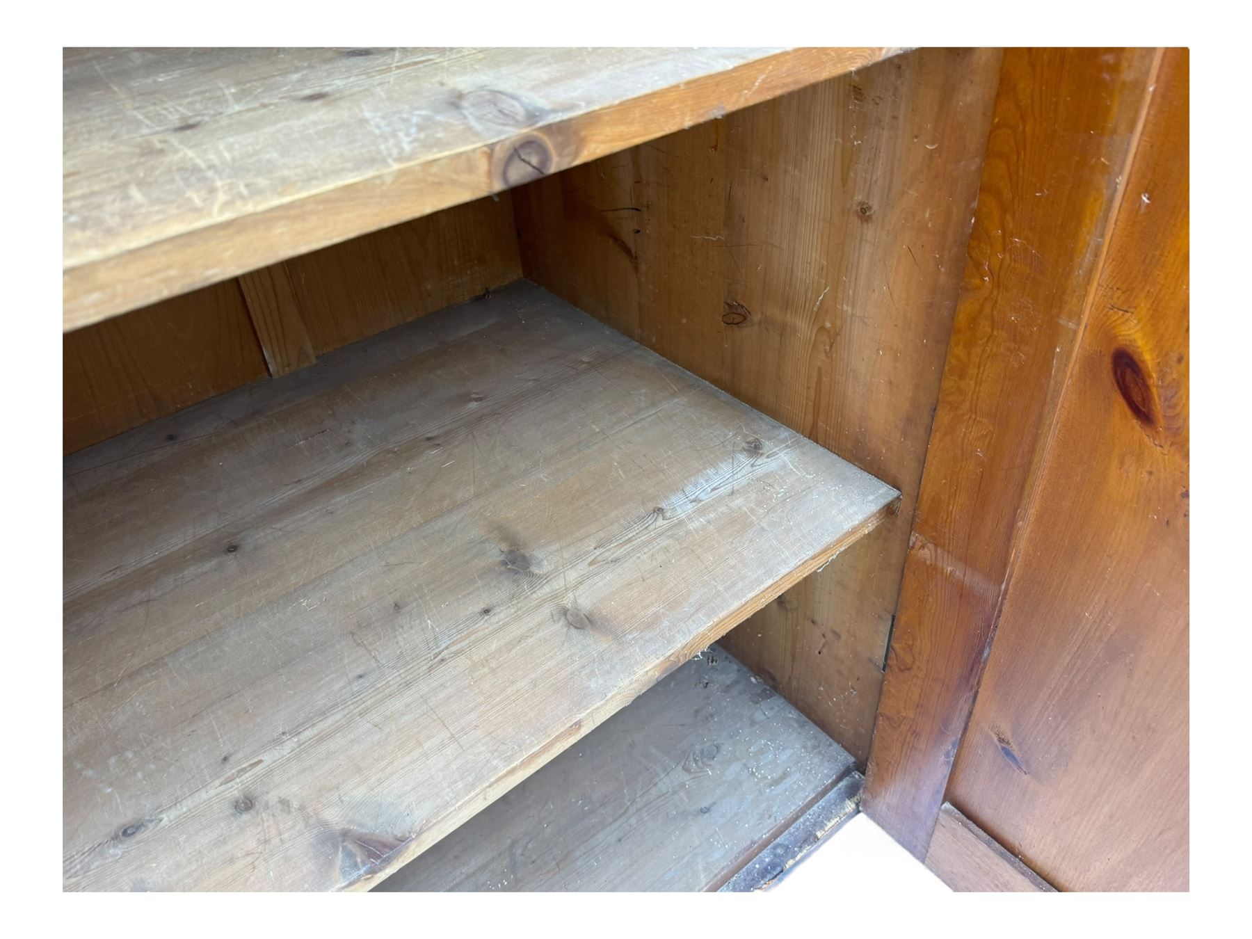 Large 19th century pine cupboard, rectangular top over two panelled later doors, enclosing four open shelves, on plinth base