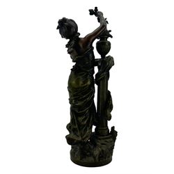 After L & F Moreau - Spelter table lamp in the form of a female figure next to a pedestal on circular naturalistic base H55cm