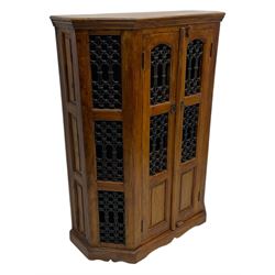 Hardwood and wrought iron cabinet, enclosed by two doors, on plinth base 