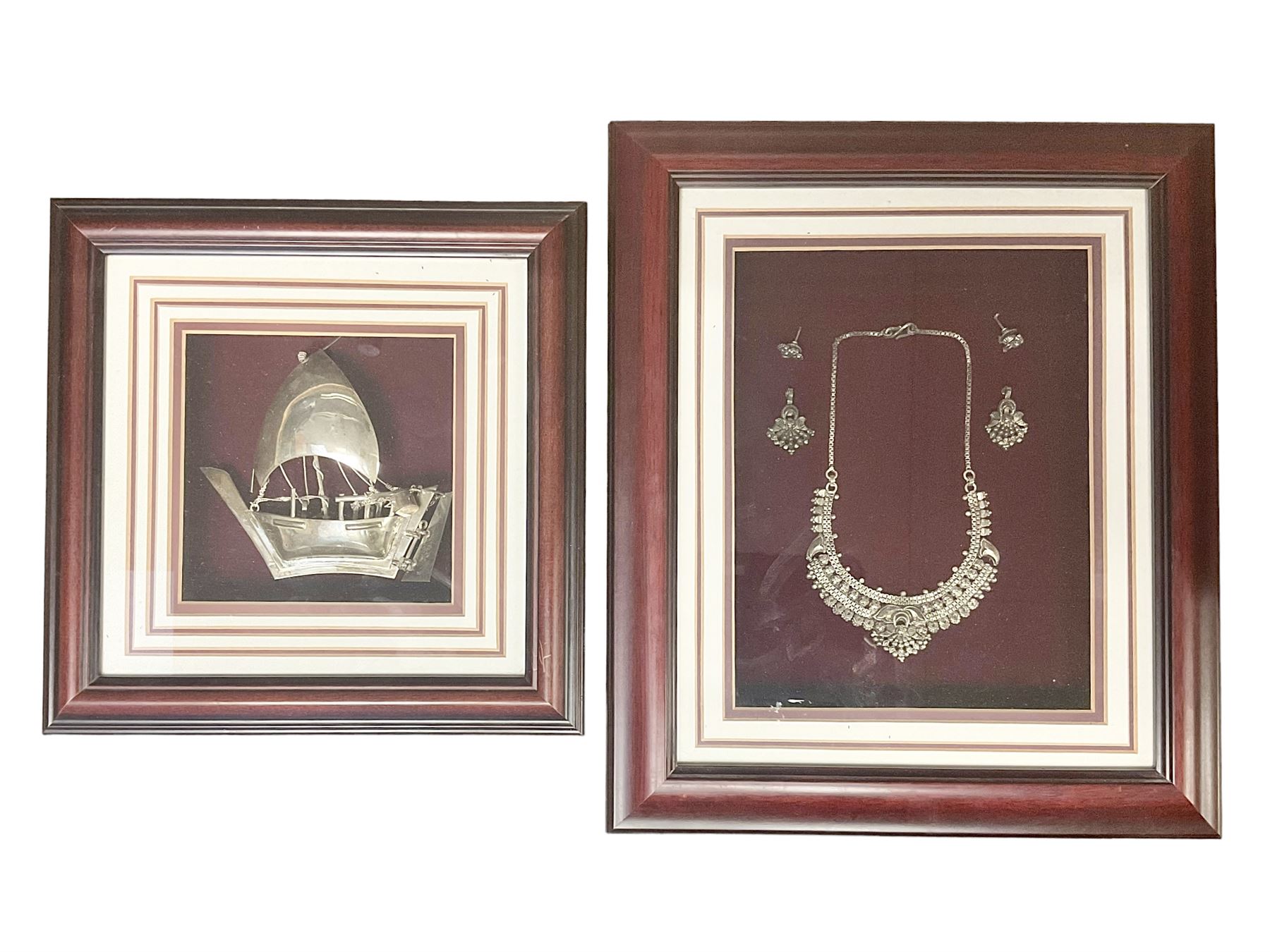 Framed Omani silver dhow sailing boat and a necklace and earring set, both in hinged wooden frames, max frame H33cm