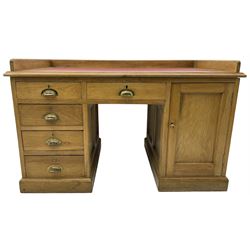 20th century oak desk, moulded rectangular top with raised back and inset leather writing surface, fitted with five drawers and single panelled cupboard, on moulded plinth base