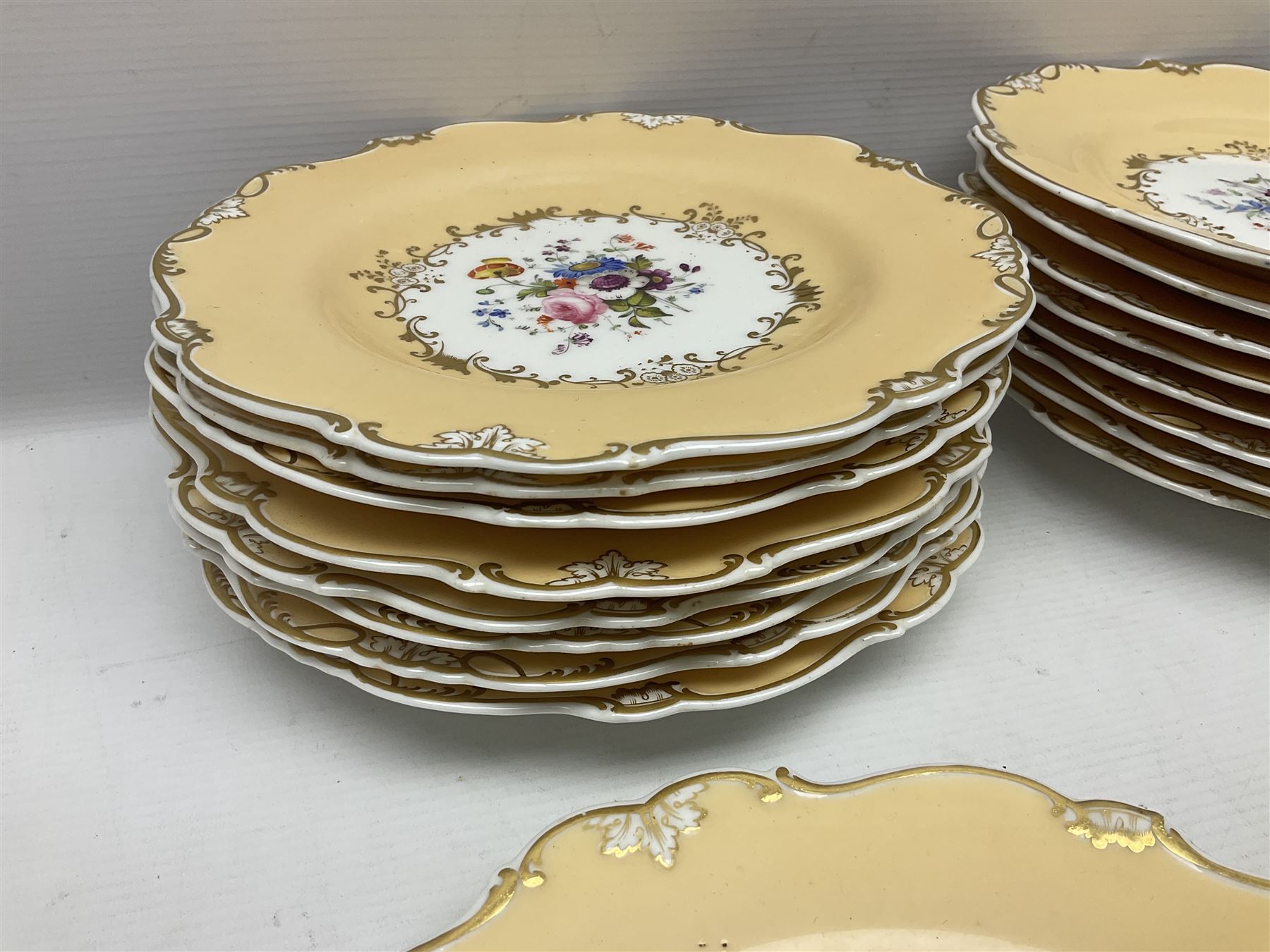 Victorian part dessert service, including eighteen plates, four small serving dishes, shallow dish, etc hand painted with floral sprigs within a cream border with floral panels, and heightened in gilt (26cm)