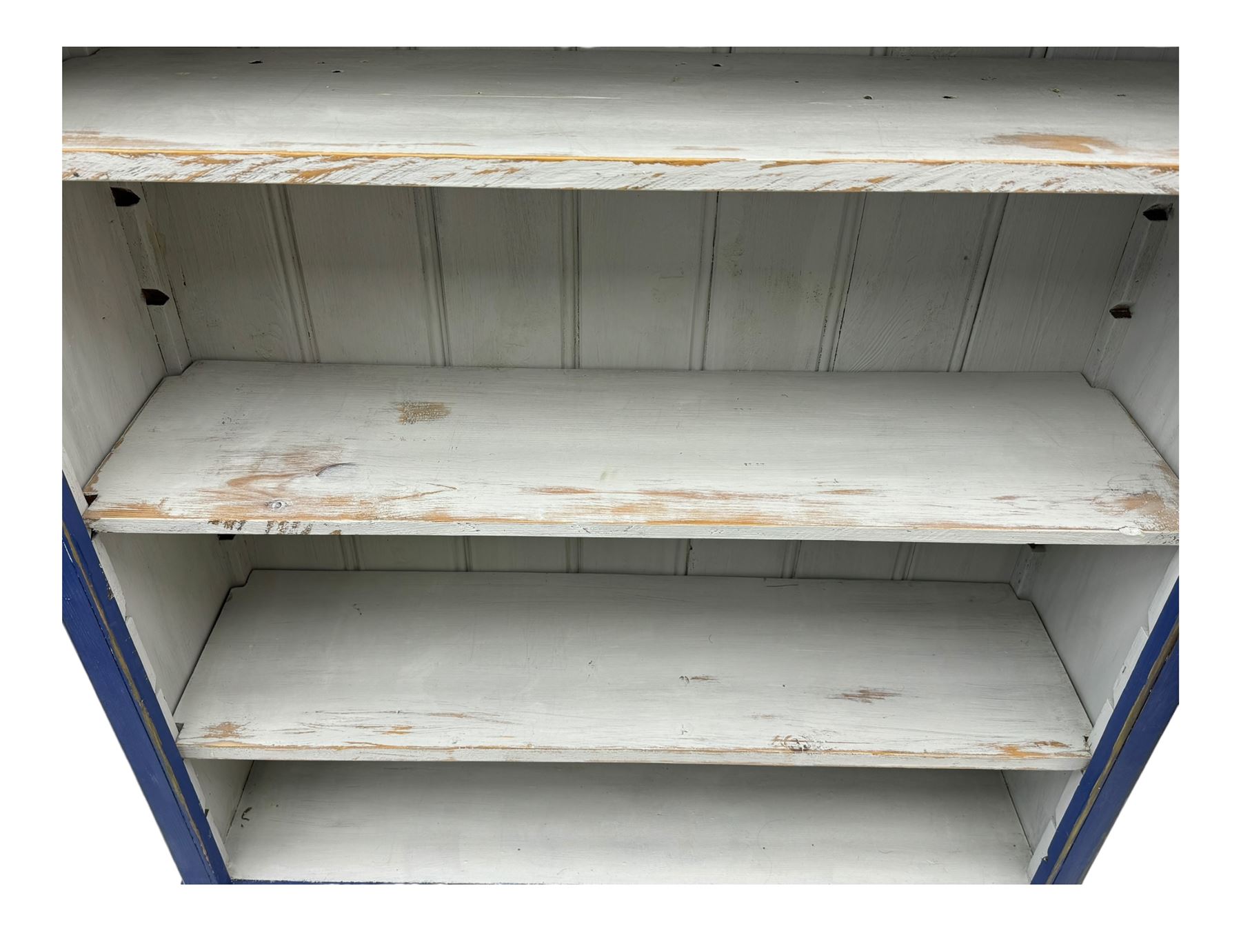 Pine blue painted open bookcase, moulded rectangular top over three white painted adjustable shelves, on plinth base