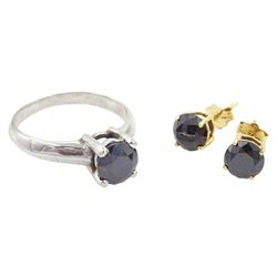 9ct white gold single stone round brilliant cut black diamond ring and a pair of 14ct yellow gold black diamond stud earrings