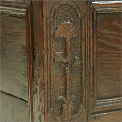 Small 18th century oak mule chest, rectangular hinged top top with moulded edge, enclosing candle box, over a double panelled front flanked by foliate carvings, single drawer fitted to base, on stile supports